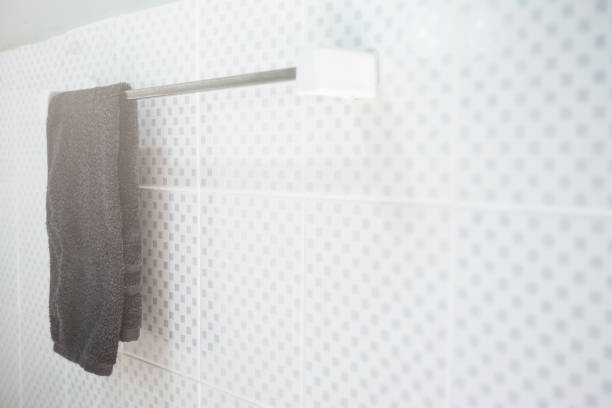 istock The towel hanging on a railing at the white wall in the bathroom. 909399082