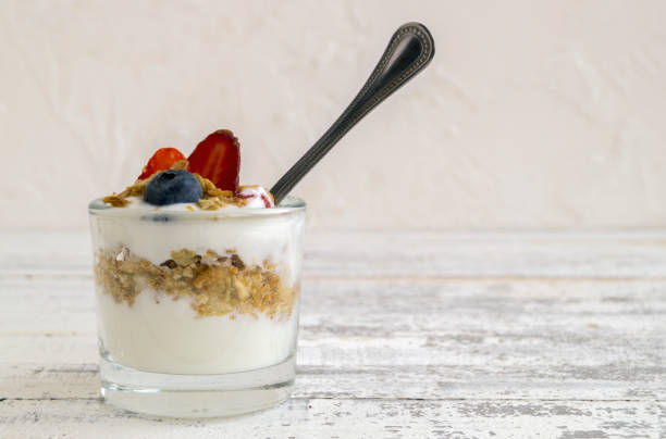 istock Natural homemade yogurt on a light background. 909403606