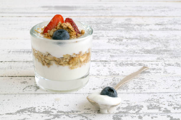 istock Natural homemade yogurt on a light background. 909403788