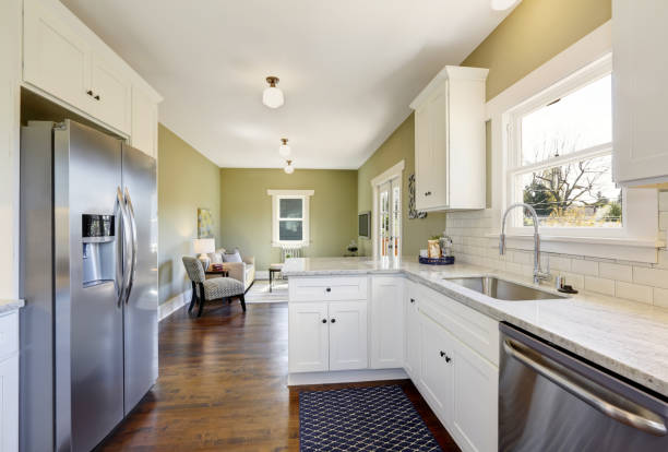 istock Freshly updated white and green kitchen room interior 909404074
