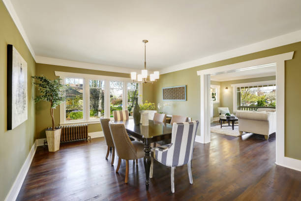 istock Light olive dining room features a wood carved dining table. 909404238