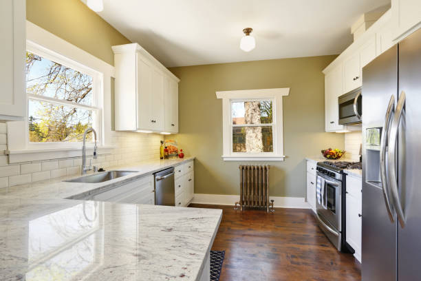 istock Freshly updated white and green kitchen room interior 909404276