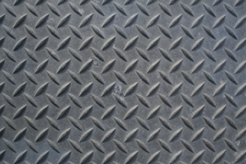 Rusty metal plate flooring with a crosshatch non-slip texture
