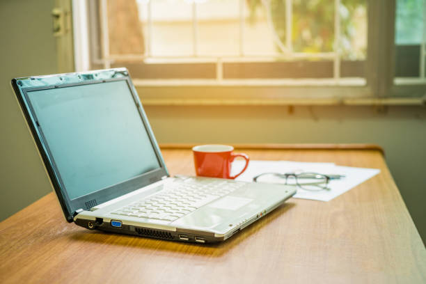 istock Office workplace with laptop and coffee cup on wood table 909406760