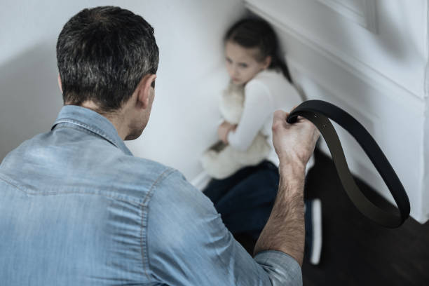 istock Scared girl sitting in the corner 909408440