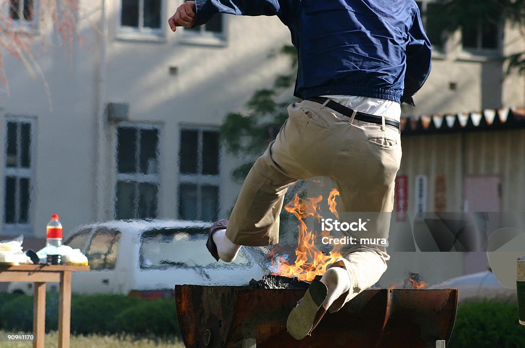 Man jumping over the fire  Bizarre Stock Photo