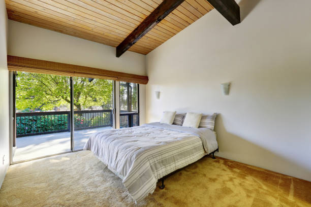 istock Light bedroom design with wood plank vaulted ceiling 909411772