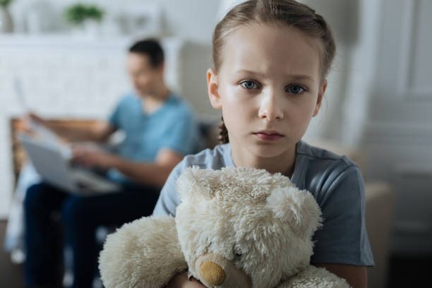 istock Sad little girl holding her toy 909414924