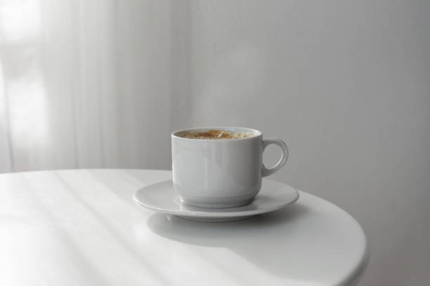 istock cup of coffee on white table 909415990