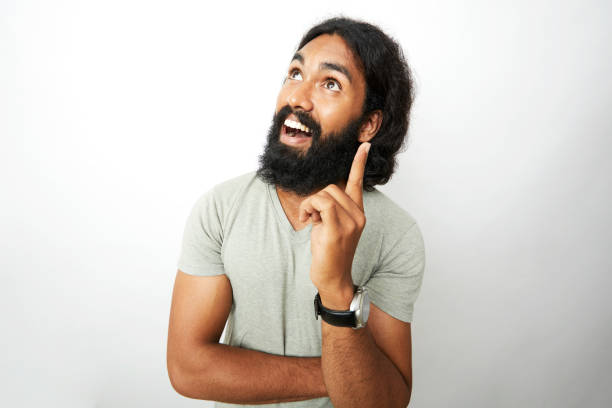 istock Young man smiling and thinking in wide angle shot 909416458
