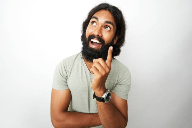 istock Young man smiling and thinking in wide angle shot 909416482