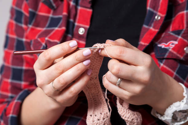 istock Young woman knittnig 909419536