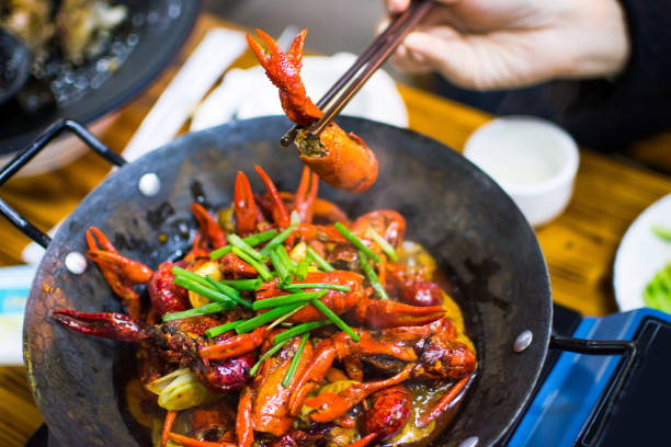 istock Chopsticks taking crayfish from spicy crayfish pot 909419892