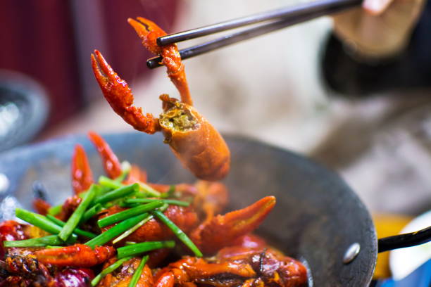 istock Chopsticks taking crayfish from spicy crayfish pot 909419940