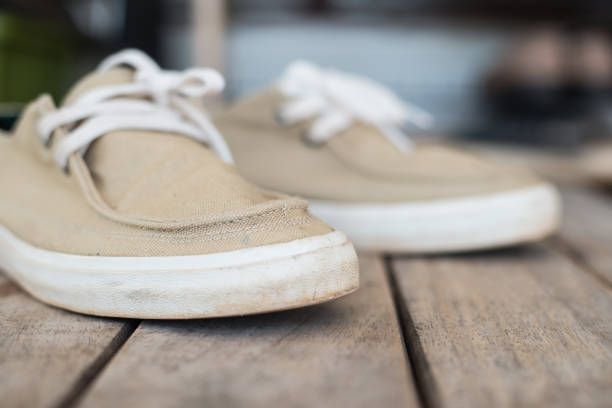 istock close up sneakers on wood texture. 909423052