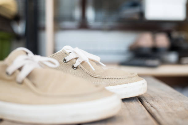 istock close up sneakers on wood texture. 909423088