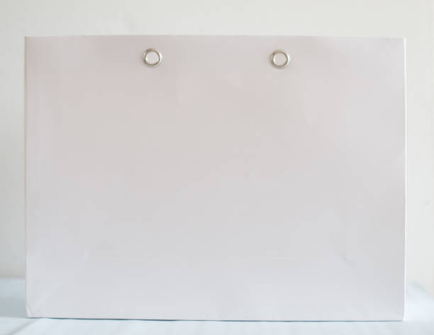 istock White paper bag on blur background. 909423174
