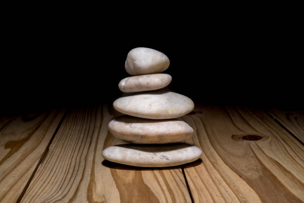 istock Stack of zen stones on wooden background 909424296