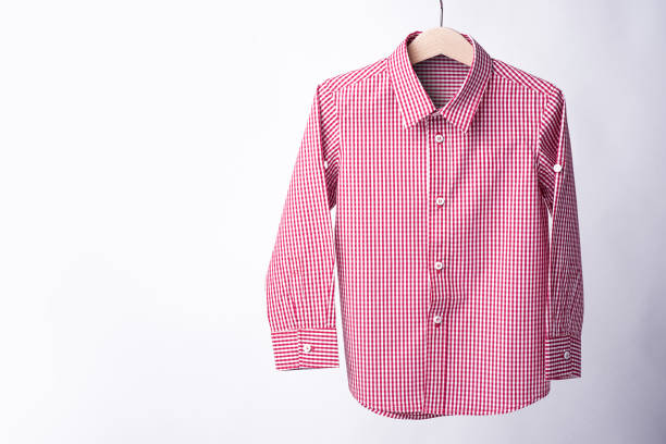 istock Red tartan shirt folded on white background 909424562