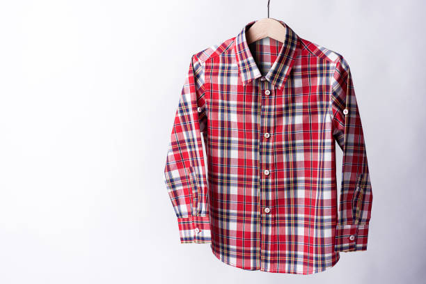 istock Red tartan shirt folded on white background 909424576