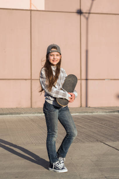 istock urban girl with skateboard 909428498