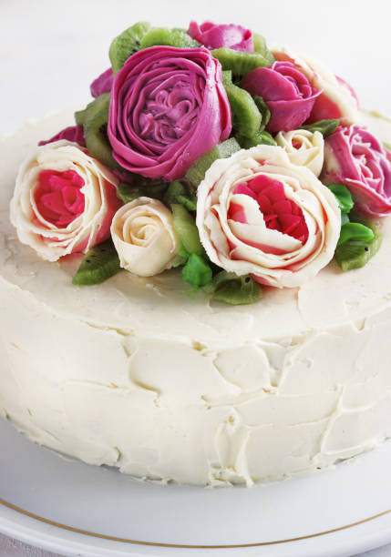 istock Birthday cake with flowers rose on white background 909432848