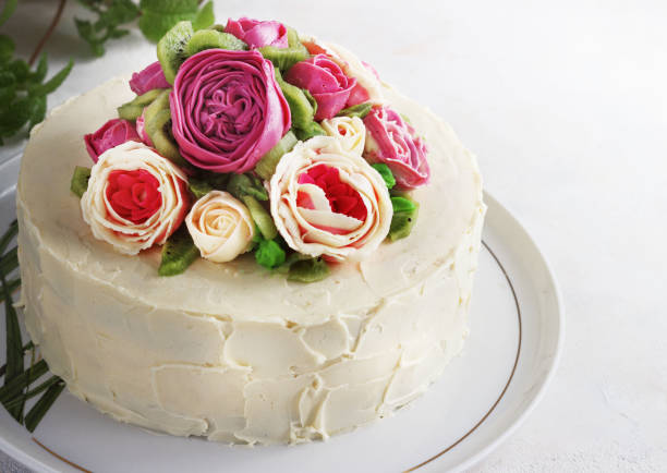 istock Birthday cake with flowers rose on white background 909432864