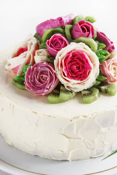 istock Birthday cake with flowers rose on white background 909433026
