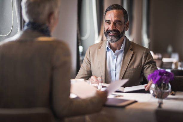 istock Happy mature man communicating with his wife in a restaurant. 909433576