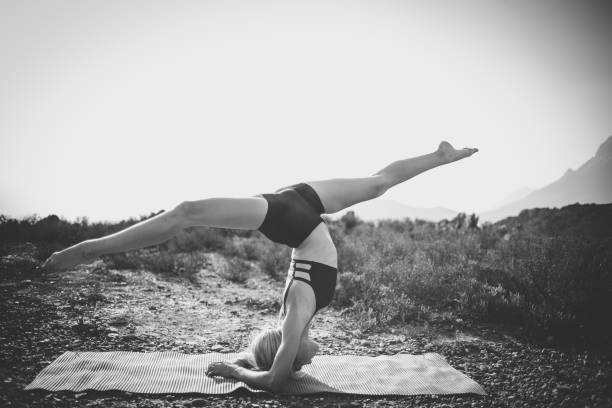 istock Female model practicing yoga in the outdoors doing stretching and exercising balance. 909436318