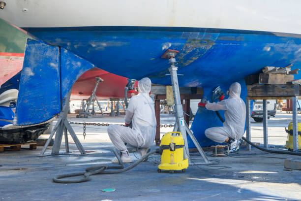 los trabajadores utilizan máquinas para el trabajo. preparación para pintura - casco parte del barco fotografías e imágenes de stock