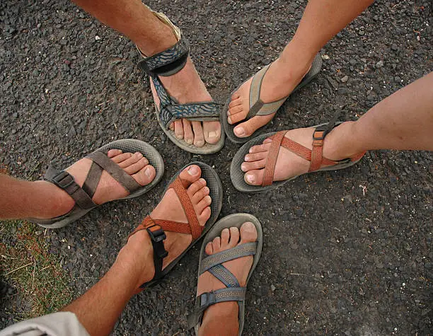 Photo of Many different feet and sandals form a circle