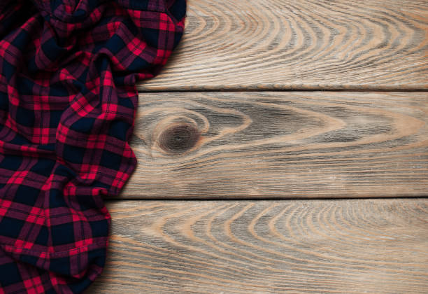 istock Checkered napkin on a wooden background 909439886