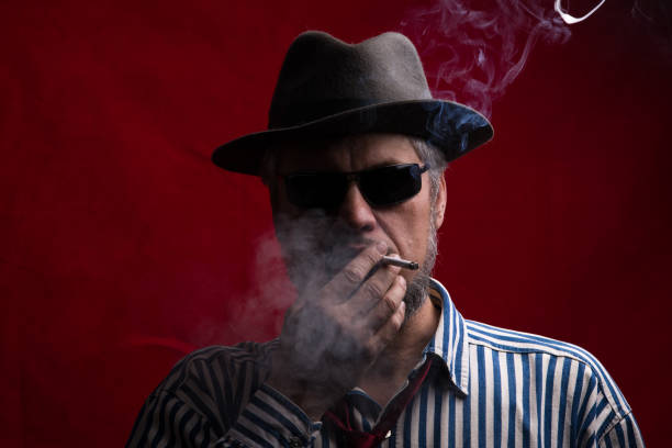 istock portrait of a bearded man in a hat and with a cigarette 909441004
