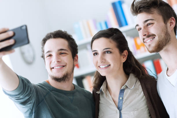 istock Teenagers taking selfies with a mobile phone 909444366