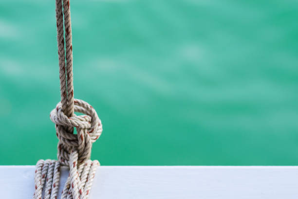 White steel with rope on ferry and sky blue ocean on background.Space for text or character on the right of picture.