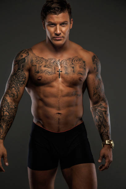 istock Shirtless muscular tattooed man. 909446010