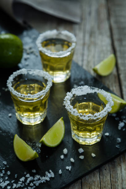 istock Gold tequila with lime and salt 909446352