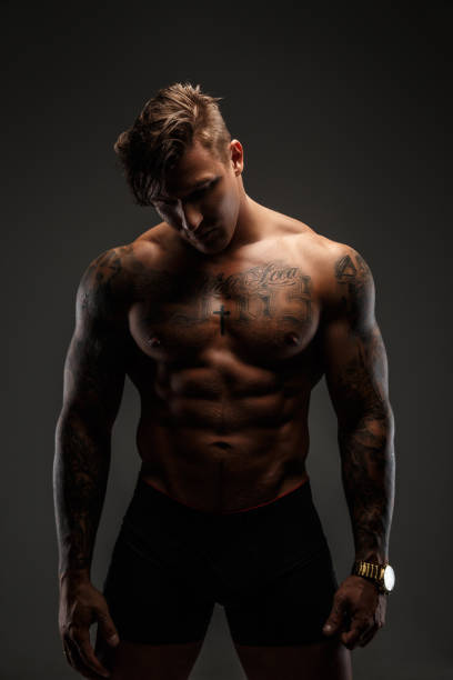 istock Portrait of muscular tattooed man 909448538