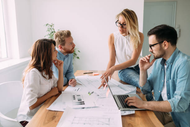 istock Group of young business people and architects working on project 909449516