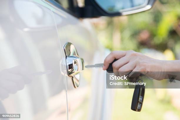 Woman Hand Holding The Remote Control To Unlock The Car Door Stock Photo - Download Image Now