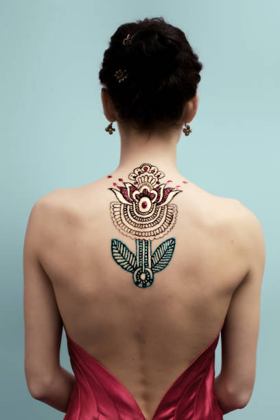 beauty girl Hennaed beautiful female back, mandala flower image, traditional Indian, Pakistani, African, Oriental motivs, cultural traditions, customs. Mehendi made of brown, red, green henna paste. Professional back shoulder tattoos for women pictures stock pictures, royalty-free photos & images