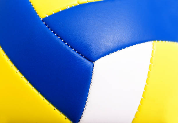Colorful volleyball ball and red line on top of the sand.