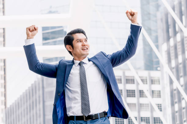istock Successful businessman celebrating with arms up 909453818