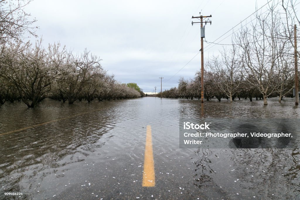 A flooded road near Chico, California CHICO, CALIFORNIA - FEBRUARY 20: An atmospheric river extreme weather event causes the Sacramento River to flood nearby farmland on February 20, 2017 in Chico, California. California Stock Photo