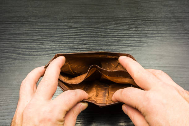 istock A person looks into an empty wallet. 909454654