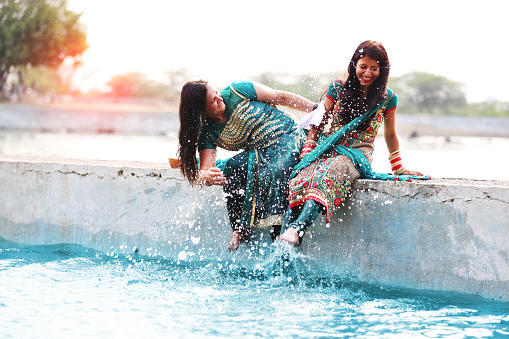 Dos mujer haciendo diversión en el agua del lago photo