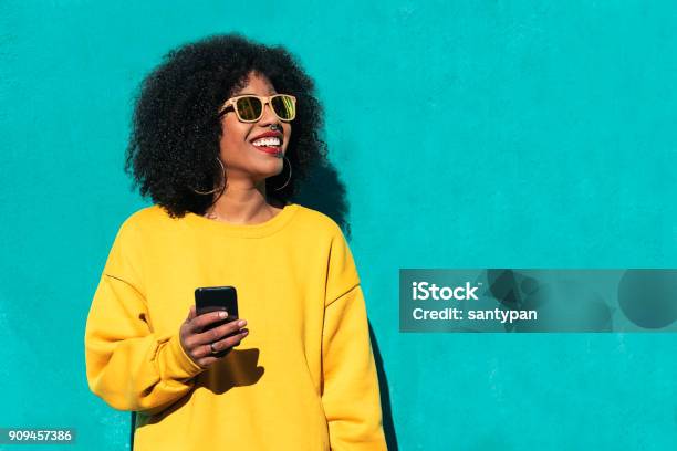 Beautiful Afro American Woman Using Mobile In The Street Stock Photo - Download Image Now