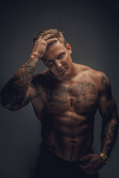 istock Shirtless man with tattoo. 909460416