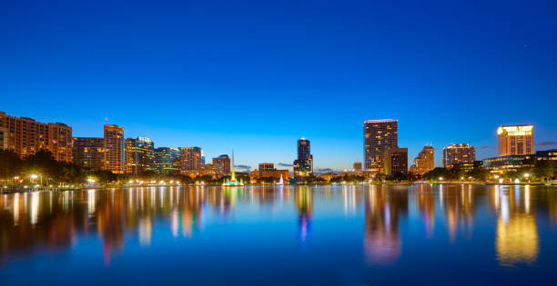 istock Orlando skyline sunset at lake Eola Florida US 909460492